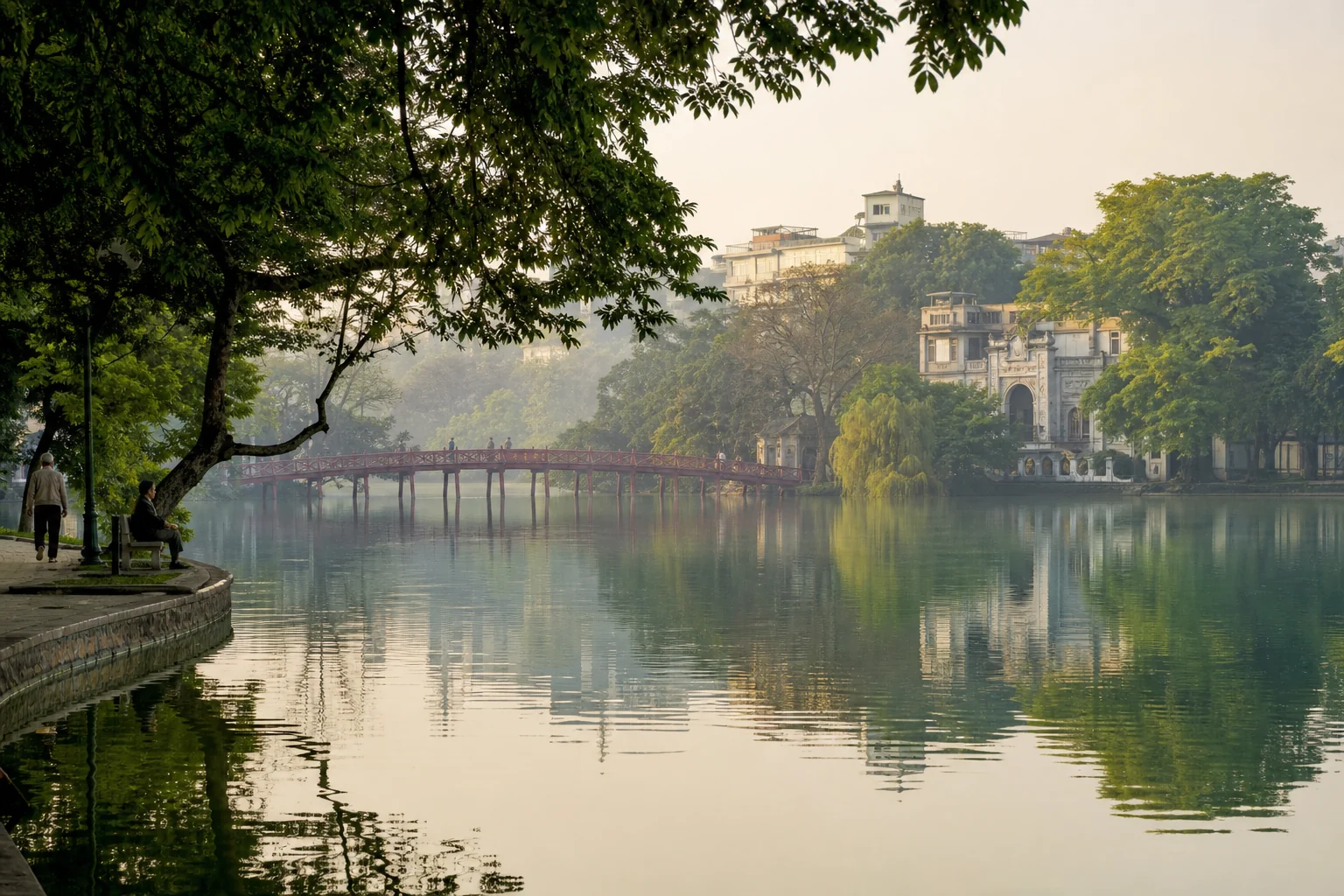 Hoan Kiem Lake and the red Huc Bridge in Hanoi at sunrise